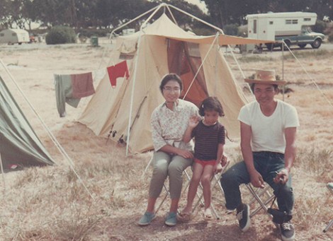 Hirahara at around six years old during her family's regular summer camping trips along the California coast. Her mother Mayumi is on the left and father Isamu is on the right. Her younger brother, Jimmy, was born when she was eight and a half years old.